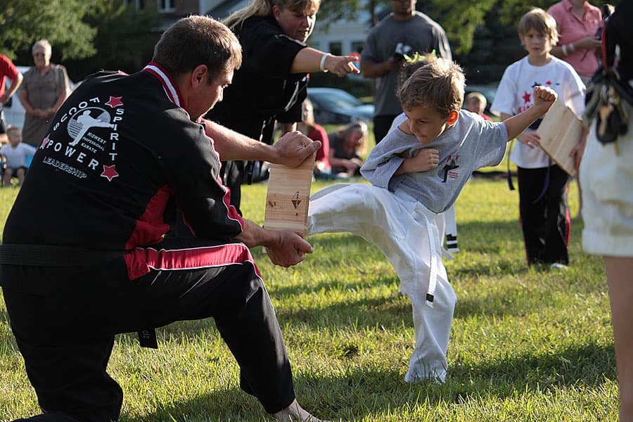 Child kicking a board in the park